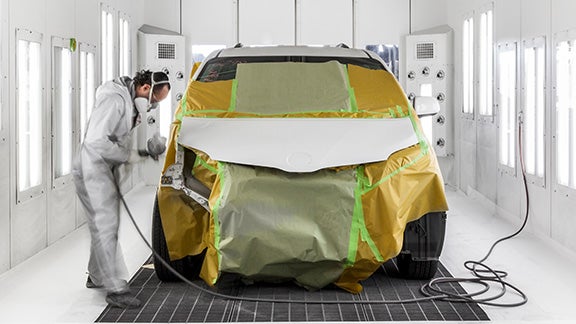 Collision Center Technician Painting a Vehicle | Mike Kelly Toyota of Uniontown in Uniontown PA