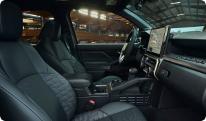 The front seats and dashboard touchscreen inside a Toyota Tacoma