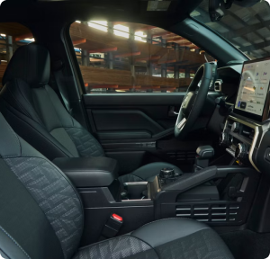 The front seats and dashboard of a Toyota truck cabin with a large touchscreen