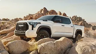 White Toyota Tundra TRD Pro parked among large desert boulders