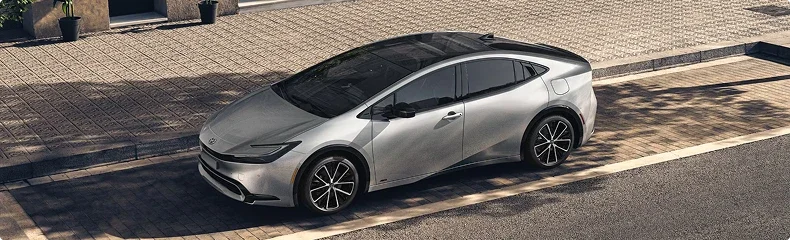 A silver Toyota Prius parked on a paved drive, seen from above