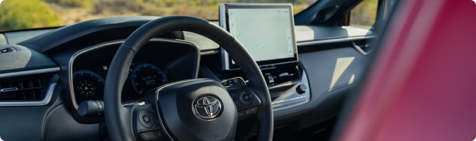 2026 Toyota Corolla Cross dashboard with the steering wheel, driver display and touchscreen